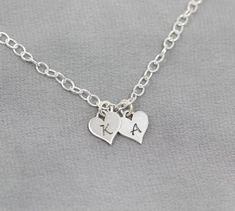 This sweet bracelet, featuring your initials engraved on Sterling Silver hearts, is sure to make her smile. Show her your love by personalizing this Sterling Silver bracelet as a thoughtful gift for a birthday, anniversary or Christmas. The Sterling Silver chain can be cut to your preferred length (standard is 7 1/2") and features an adjustable clasp so that she can adjust it to fit.TO ORDER -- Please select the initials that you would like from the drop down menus. Please include the length tha Personalized Sterling Silver Heart Bracelet, Customizable Charm Bracelet For Valentine's Day Friendship, Personalized Double Heart Bracelet For Mother's Day, Personalized Initials Bracelets For Valentine's Day, Personalized Initials Bracelet For Valentine's Day, Sterling Silver Heart Bracelet For Personalized Gift, Silver Heart Bracelet For Anniversary, Sterling Silver Heart Bracelet As Personalized Gift, Personalized Heart Pendant Bracelets For Anniversary