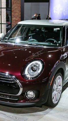 a mini cooper is on display at an auto show