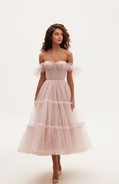 The tulle cocktail dress features a semi-transparent bustier with corset lacing, ruffle sleeves, and a partially lined skirt. Material: Tulle Composition: 100% polyester Skirt length from waist: 35.4 inches Dress weight: 3.52 lbs Neckline: Heart-shaped Back: Lace-up closure Built-in cups Lining: Light blue short underskirt Machine wash gentle cycle up to 86ºF Do not bleach Steam up to 250ºF Dry cleaning allowed Do not tumble dry Dry vertical Store hanging with inner straps on a notched hanger, p Milla Dresses, Bachelorette Theme, Tulle Cocktail Dress, Corset Lacing, Winter Wedding Guest Dress, Pink Tulle Dress, Tulle Party Dress, Tulle Midi Dress, Dress Weights