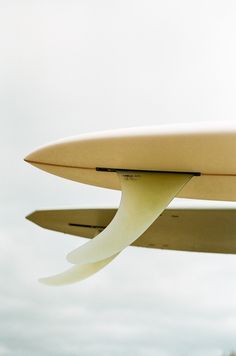 the underside of a surfboard flying in the air