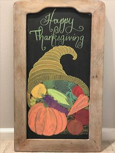 a chalkboard sign with the words happy thanksgiving written on it