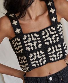 a woman wearing a black and white crop top