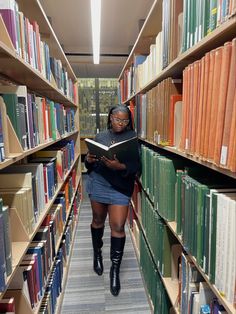 a woman reading a book in a library