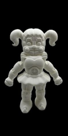 a white plastic toy that looks like an alien