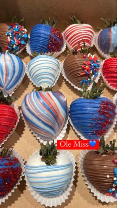 chocolate covered strawberries with red, white and blue decorations on them in a box