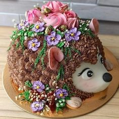 a cake decorated with flowers and a hedge