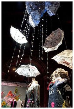 several umbrellas are hanging from the ceiling