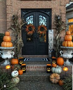 pumpkins and gourds decorate the front porch for halloween