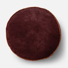 a brown round cushion on a white background