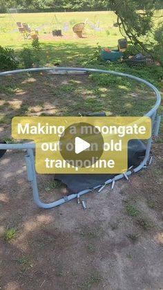 an empty trampoline sitting in the middle of a field with a sign that says making amonogate out on old trampoline