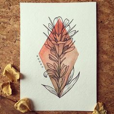 a piece of paper with a drawing of a flower on it next to some leaves