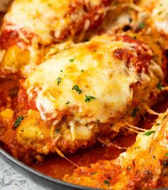 a pan filled with chicken parmesan covered in cheese