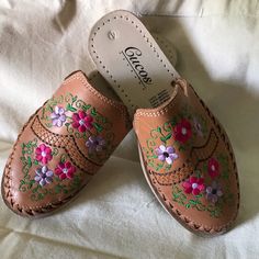 Detailed Brown Embroidered Sandals. Closed Front And Open Back. Size On Shoes Says 4 But It Will Fit Anyone Size 5 Through 6.5 (In Us Sizes). Originally Bought At $40 And Never Worn. Spring Bohemian Clogs With Round Toe, Traditional Pink Sandals With Round Toe, Traditional Open Toe Spring Clogs, Traditional Closed Toe Mules For Spring, Pink Bohemian Slip-on Sandals, Traditional Open Toe Clogs For Spring, Embroidered Brown Sandals, Traditional Closed Toe Sandals With Floral Embroidery, Brown Embroidered Sandals