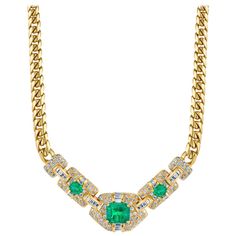 An elegant emerald diamond necklace featuring a 4.35 carat vivid green emerald cut emerald which we believe to have Columbian origin. Two smaller emeralds complement the centerpiece which is covered in approximately 4.50 carats of baguette and full-cut diamonds, set in 18k yellow gold. Necklace Length: 16.5 inches Luxury Emerald Diamond Necklace With Brilliant Cut, Emerald Cut Green Diamond Necklace, Green Emerald-cut Diamond Necklace, Green Emerald Baguette Cut Necklace, Luxury Emerald-cut Emerald Diamond Necklace, Flowers Rings, Emerald Diamond Necklace, Diamond Gold Necklace, Silver Gold Necklace