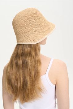 Perfect for Beach Adventures This handmade adjustable crochet straw bucket hat is perfect for sunny days at the beach or casual outings. Made from 100% raffia, it features an adjustable drawstring for a comfortable fit and easy storage. The natural raffia material provides breathability and sun protection, while the crochet design adds a touch of elegance. This versatile hat is a must-have accessory for your summer wardrobe, combining functionality with style. Style #: WWAJ550 Vacation Bucket Sun Hat, Lightweight Casual Paper Straw Hat, Casual Lightweight Paper Straw Hat, Lightweight Natural Color Casual Bucket Hat, Lightweight Paper Straw Bucket Hat For Spring, Casual Lightweight Natural Bucket Hat, Summer Bucket Hats For Beach Season, Straw Crochet Hat For Warm Weather, Casual Woven Bucket Hat For Warm Weather