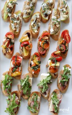 a white plate topped with lots of different types of breads and veggies