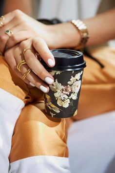 a woman's hands holding a coffee cup