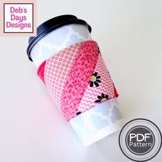 a coffee cup with pink and white designs on it