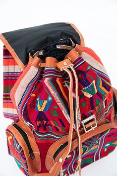 One of a Kind - ﻿﻿Guatemalan Huipil Bag The ultimate back-to-school backpack, each of these Guatemalan leather backpacks is as colorful as it is cultural. Each colorful backpack is handmade from sueded leather and huipil fabric used for traje tipico or traditional dress in different regions of Guatemala. Coupled with padded backs made of multicolored traditional jaspe textiles, each one of these colorful leather backpacks is as unique as you are. The red huipil fabrics are from the town of Nebaj Handmade Leather Backpack, Mayan Culture, Back To School Backpacks, Colorful Backpacks, Leather Backpacks, School Backpack, Colored Leather, Traditional Dress, Naturally Dyed