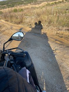 a person riding a motorcycle on a dirt road