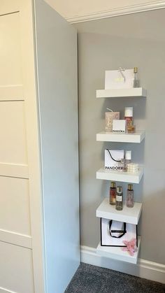 a white shelf in the corner of a room