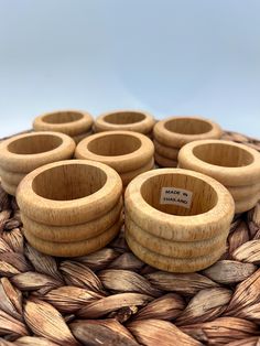 six wooden bowls sitting on top of a woven basket