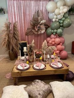 a table set up with balloons and plates