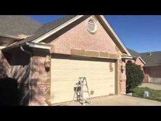 a house that has a ladder in front of it and a car parked next to it