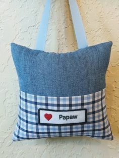 a blue and white pillow with a tag that says papaw on the front