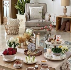 a living room filled with furniture and lots of food on top of a coffee table