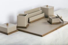 several pieces of furniture sitting on top of a white surface with wood trimmings