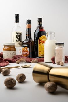 nuts, milk, and other ingredients are sitting on a table next to some bottles