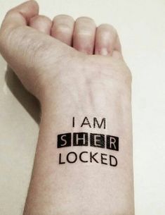 a person with a wrist tattoo that says i am sher locked