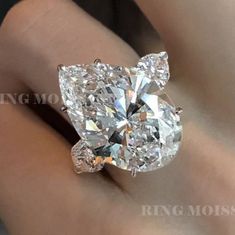 "Three stone moissanite pear shaped engagement ring,celebrity style,unique heart&13 CT huge large pear 3 stone moissanite gold wedding ring → Occasions: Engagement & Wedding DESCRIPTION -------------------- STYLE :Three stone *Moissanite Details →Main Stone :Pear →Size (mm) :20*13 →Carat weight :13 →Band & Halo & Side Stone :heart →Size (mm) :5*5 →Carat Weight :0.9 →Stone Total CTW :13.9 → Color : Colorless →Clarity :VVS →Metal :SOLID (10K/14K/18K )GOLD →Band Width :2.5 mm * Purchasing Option: → Cubic Zirconia Pear-shaped Promise Ring, Teardrop Cubic Zirconia Jewelry For Anniversary, Exquisite Pear-shaped Diamond White Diamond Ring, Pear-shaped Diamond White Moissanite Wedding Ring, Pear-shaped Moissanite Wedding Rings With Vvs Clarity, Pear-shaped Moissanite Ring With Vvs Clarity, Diamond White Pear-shaped Wedding Ring, Dazzling Teardrop Diamond Ring For Formal Occasions, Pear-shaped Cubic Zirconia Wedding Jewelry In Diamond White