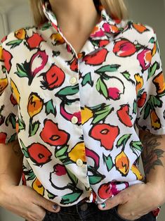 Vintage 80's button-down with colorful tulip design. Fits like Women's size M/L Retro Multicolor Print Shirt For Spring, Retro Shirt With Vibrant Spring Print, Retro Multicolor Floral Print Blouse, White Retro Floral Print Shirt, White Retro Shirt With Floral Print, Retro White Shirt With Floral Print, White Retro Print Shirt For Spring, White Shirt With Retro Print For Spring, Retro Multicolor Print Button-up Tops