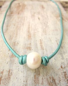 "A large 10-12mm genuine pearl is the focal of this choker style necklace. A perfect mix of elegant and rustic, casual and cool. Comes with a lobster claw clasp for extra security and ease of wear. Choose from 4 great lengths. 14\", 16\", 18\" or 20\". This necklace also available in four great colors. Turquoise (as shown) Distressed Brown Black Sun Tan See it in Black here: https://www.etsy.com/listing/226336065/black-leather-and-pearl-necklacepearl?ref=shop_home_active_9 See it in Sun Tan here Pearl Leather Necklace, Lace Choker Necklace, Multi Coloured Necklaces, Necklace Big, Leather Jewellery, Choker Style Necklace, Color Necklace, Jewelry Pearl, Turquoise Leather