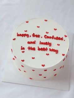 a white cake with red hearts on it that says happy birthday and lovely in the best way