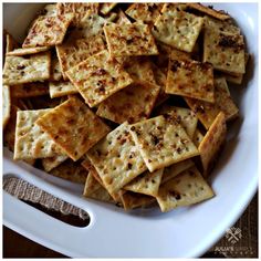 a white bowl filled with crackers on top of a table