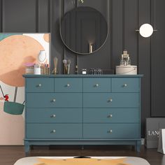 a blue dresser in a room with a mirror on the wall and other items sitting on top of it