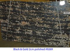 a large black and gold marble slab in a warehouse