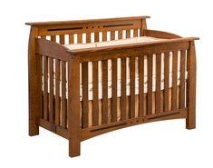 a wooden crib with white sheets on the bottom and sides, against a white background