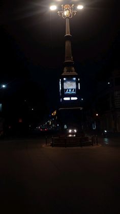 a lamp post lit up in the dark at night