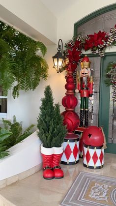 christmas decorations are on display in front of a door with a wreath and nutcracker