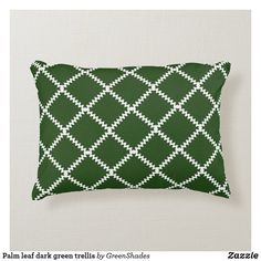 a green and white pillow that has an argyle pattern on it, along with the words palm leaf dark green tells by greenshades