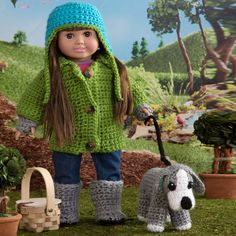 the doll is wearing a green coat and boots with a dog in front of her