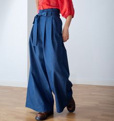 Blue denim wide trousers. High waiste. Folds on waisteline. With pockets. With wide belt. Made of soft washed blue denim.  Size 36/US6/S (waist 70cm/27,6in, hips 94cm/37in)  Size 38/US8/S (waist 74cm/29,1in, hips 98cm/38,6in)  Size 40/US10/M (waist 78cm/30,7in, hips 102cm/40,2in)  Size 42/US12/M (waist 82cm/31.9in, hips 106cm/41,3in)  Leg inseam lenght 77cm/30in 100% CO machine wash allowed Wide-leg Jeans For Work In Medium Wash, Wide-leg Denim Jeans For Work, Denim Wide Leg Pants For Work, Chic Baggy Dark Wash Bottoms, Baggy Medium Wash Pants With Belt Loops, Indigo Wide Leg Bottoms For Spring, Spring Indigo Wide Leg Bottoms, Medium Wash Full Length Wide Leg Work Pants, Denim High-waisted Wide Leg Workwear Pants