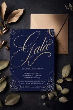 an elegant navy blue and gold wedding card with the word gala on it, surrounded by greenery