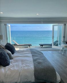 a bedroom with an ocean view is shown