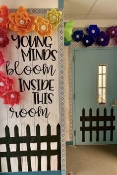 a door decorated with paper flowers and the words young minds bloom inside this room