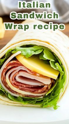 a sandwich wrap with meat, cheese and lettuce in it on a white plate